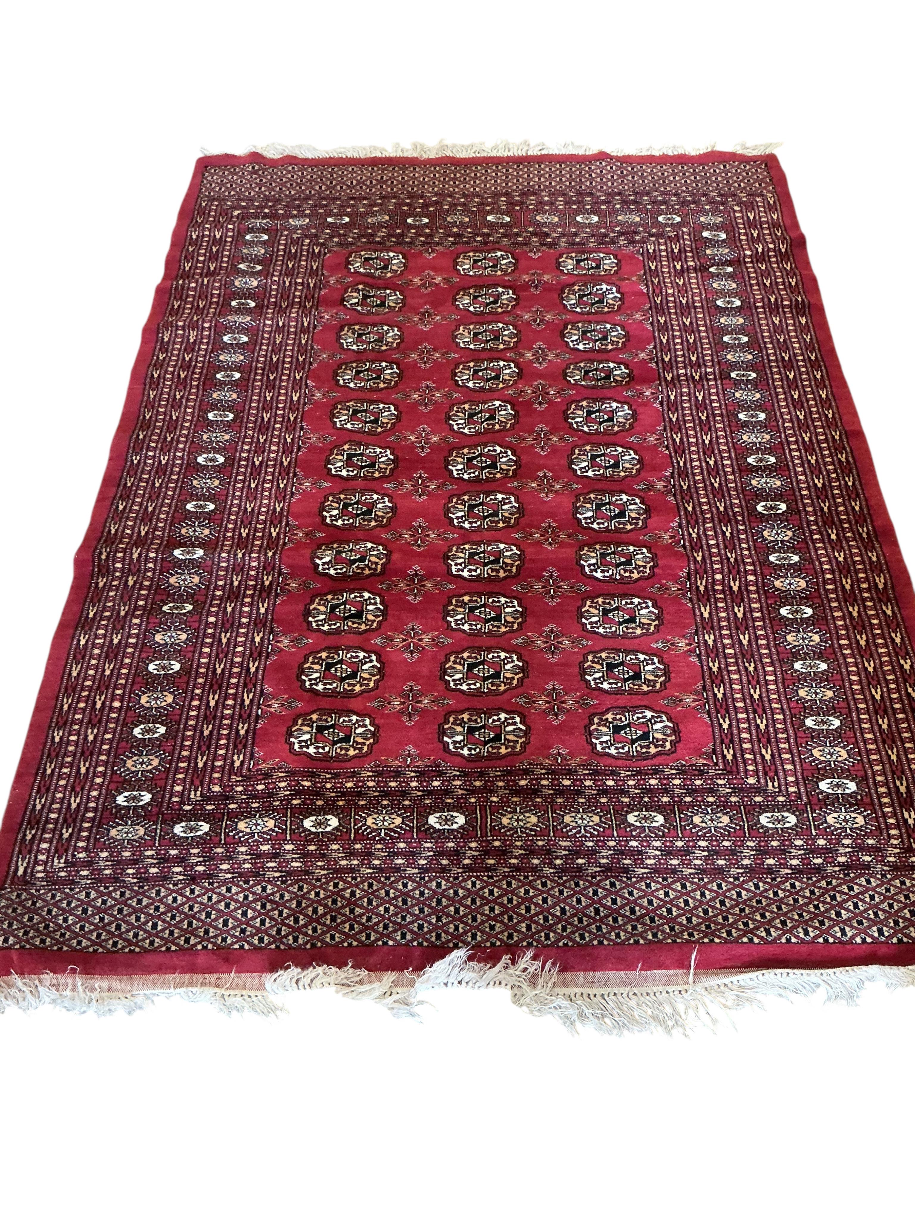 A Bokhara red ground rug, 180 x 130cm